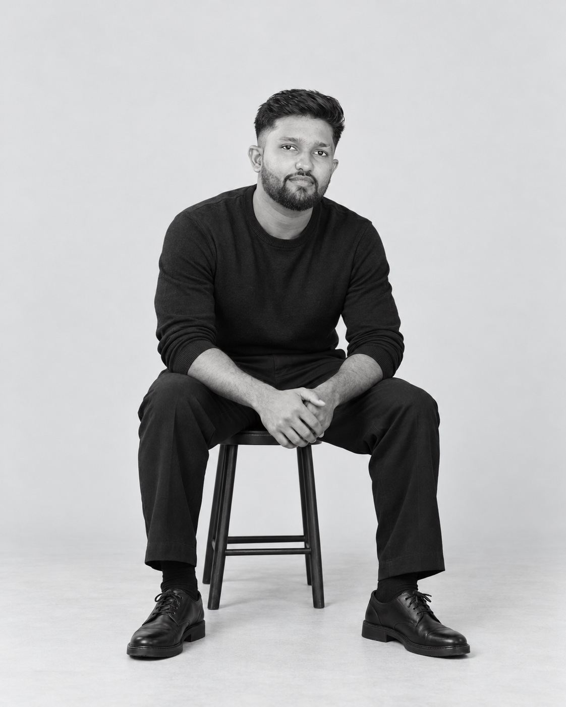Black-and-white AI-assisted studio portrait of Kanishka Dilhara, based on his photograph.